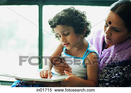 Mother and young daughter reading a book together View Large Photo Image Stock Photography - Mother and young daughter reading a book together. Fotosearch