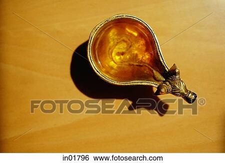 Stock Photograph - Still life of oil lamp, high angle view. Fotosearch