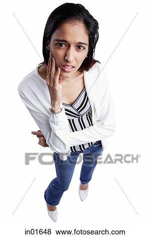 Woman against white background, looking up at camera, hand on chin View Large Photo Image Stock Photo - Woman against white background, looking up at camera, hand on chin. Fotosearch