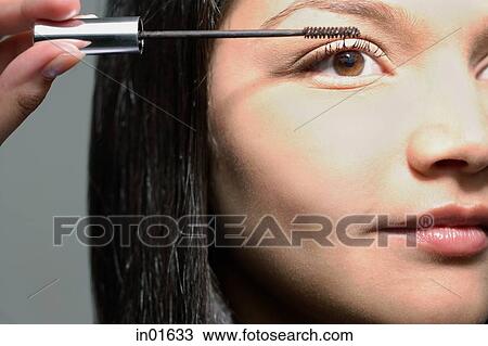 Woman applying mascara View Large Photo Image Stock Image - Woman applying mascara. Fotosearch