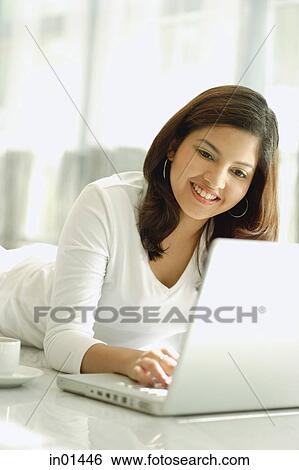 Woman at home with laptop View Large Photo Image Stock Photograph - Woman at home with laptop. Fotosearch