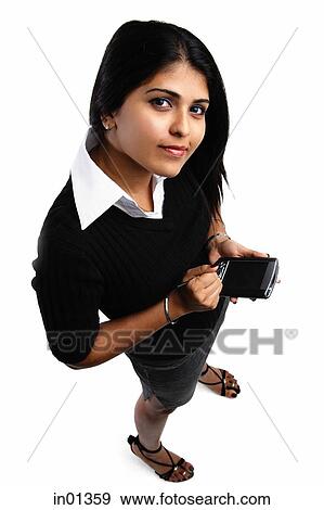 Woman holding PDA, looking up at camera View Large Photo Image Stock Photo - Woman holding PDA, looking up at camera. Fotosearch