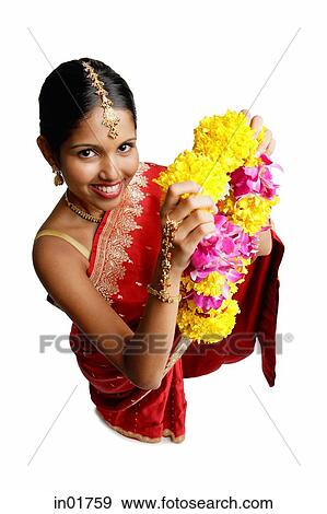 Woman in sari, holding flower garland, high angle view View Large Photo Image Stock Photo - Woman in sari, holding flower garland, high angle view. Fotosearch