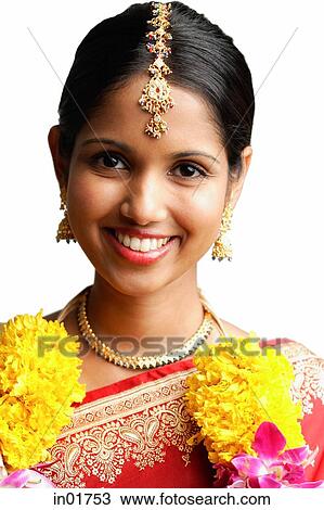Woman in sari wearing a garland, smiling at camera, head shot View Large Photo Image Stock Image - Woman in sari wearing a garland, smiling at camera, head shot. Fotosearch