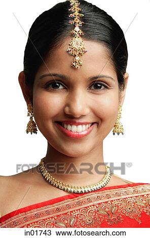 Woman in traditional Indian attire smiling at camera View Large Photo Image Stock Image - Woman in traditional Indian attire smiling at camera. Fotosearch