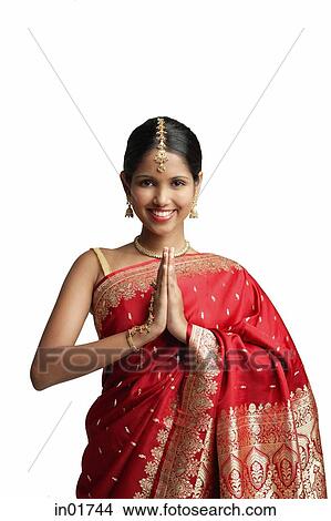 Woman in traditional Indian costume, standing with hands together, smiling at camera View Large Photo Image Picture - Woman in traditional Indian costume, standing with hands together, smiling at camera. Fotosearch