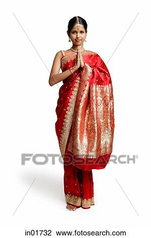 Stock Image - Woman in traditional Indian costume, standing with hands together. Fotosearch
