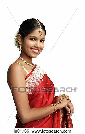 Stock Photograph - Woman in traditional Indian costume standing against white background. Fotosearch