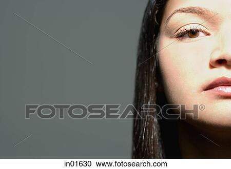 Stock Image - Woman looking at camera, cropped. Fotosearch