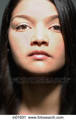 Stock Image - Woman looking at camera, portrait. Fotosearch