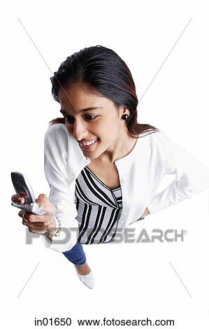 Woman looking at mobile phone, high angle view View Large Photo Image Stock Image - Woman looking at mobile phone, high angle view. Fotosearch