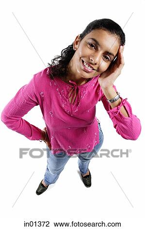 Stock Image - Woman looking up at camera, hand on head. Fotosearch