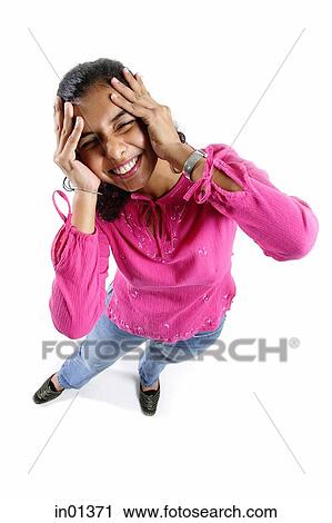 Woman looking up at camera, hands on head View Large Photo Image Stock Image - Woman looking up at camera, hands on head. Fotosearch