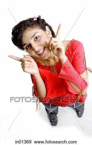 Stock Photo - Woman looking up at camera, pointing. Fotosearch