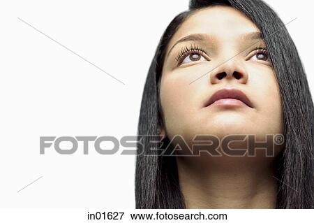 Stock Photo - Woman looking up, head shot. Fotosearch