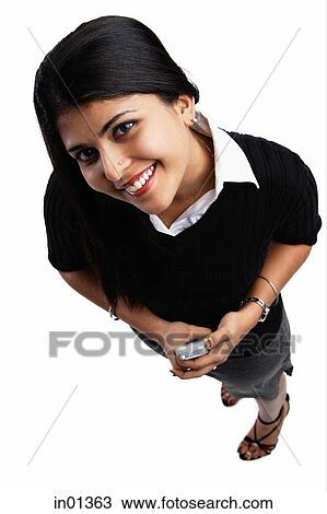 Woman smiling at camera, holding PDA View Large Photo Image Stock Image - Woman smiling at camera, holding PDA. Fotosearch