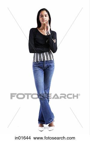 Woman standing against white background, hand on chin View Large Photo Image Picture - Woman standing against white background, hand on chin. Fotosearch