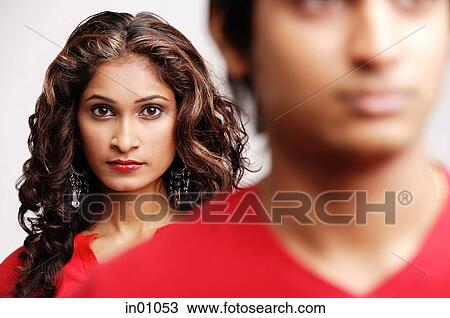 Stock Image - Woman standing behind man. Fotosearch