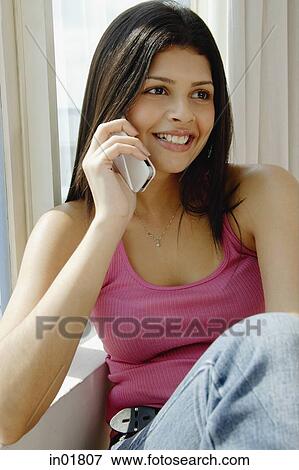 Woman using mobile phone, looking away View Large Photo Image Stock Photo - Woman using mobile phone, looking away. Fotosearch