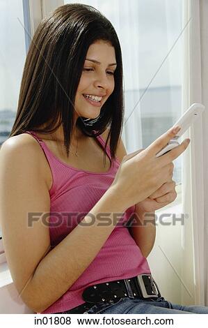 Woman using mobile phone, text messaging View Large Photo Image Stock Photo - Woman using mobile phone, text messaging. Fotosearch