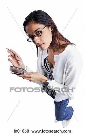 Woman using PDA, looking up at camera, high angle view View Large Photo Image Stock Photo - Woman using PDA, looking up at camera, high angle view. Fotosearch