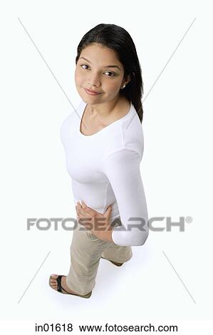 Stock Photo - Woman with hands on hips, looking at camera. Fotosearch