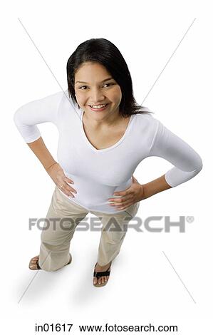 Woman with hands on hips, smiling at camera View Large Photo Image Stock Photo - Woman with hands on hips, smiling at camera. Fotosearch