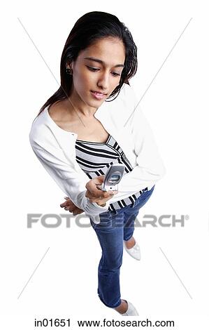 Stock Image - Woman with mobile phone, high angle view. Fotosearch