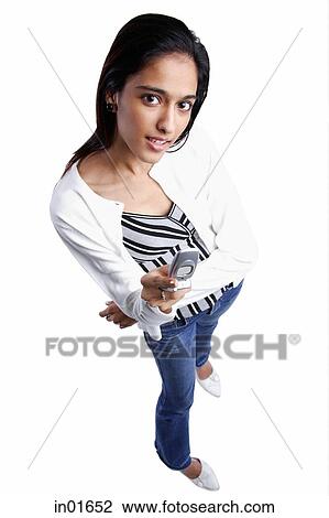 Woman with mobile phone looking at camera, high angle view View Large Photo Image Stock Image - Woman with mobile phone looking at camera, high angle view. Fotosearch