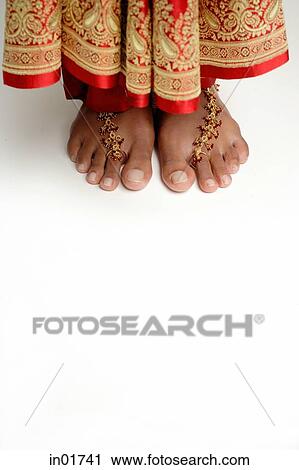 Stock Image - Woman's feet standing on white floor. Fotosearch