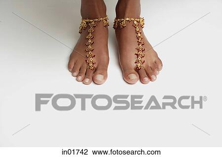 Woman's feet with anklet against white floor View Large Photo Image Stock Image - Woman's feet with anklet against white floor. Fotosearch