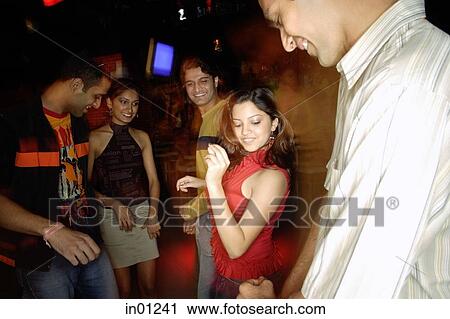 Stock Image - Young adults dancing in night club. Fotosearch