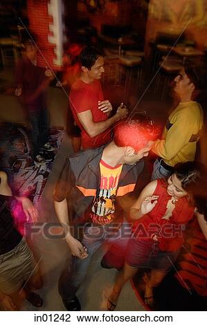 Young adults dancing in night club, high angle view View Large Photo Image Stock Image - Young adults dancing in night club, high angle view. Fotosearch