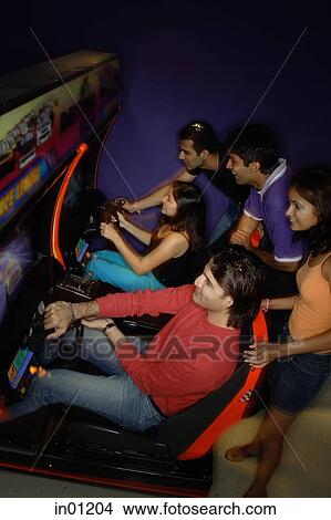 Young adults in amusement arcade View Large Photo Image Picture - Young adults in amusement arcade. Fotosearch