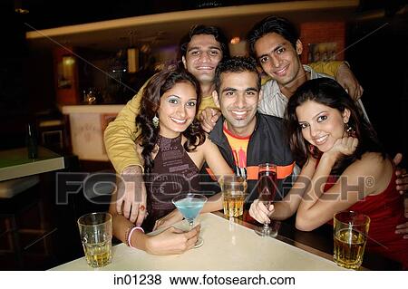 Young adults in club, smiling at camera View Large Photo Image Stock Photo - Young adults in club, smiling at camera. Fotosearch
