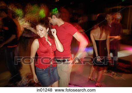 Stock Photo - Young adults in night club, dancing. Fotosearch