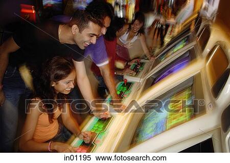 Young adults in video arcade, playing games View Large Photo Image Stock Photography - Young adults in video arcade, playing games. Fotosearch