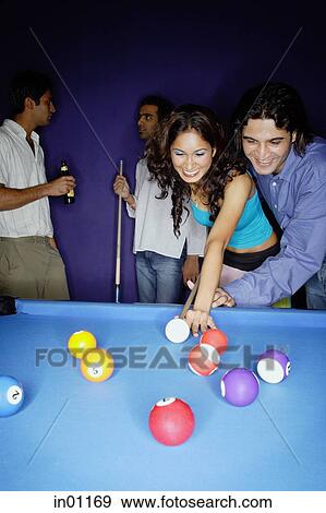 Young adults playing pool, man teaching woman to aim View Large Photo Image Stock Photo - Young adults playing pool, man teaching woman to aim. Fotosearch