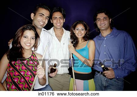 Young adults standing together, holding pool cue and beer bottles, smiling at camera View Large Photo Image Stock Photograph - Young adults standing together, holding pool cue and beer bottles, smiling at camera. Fotosearch