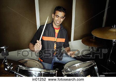Young man playing drums View Large Photo Image Stock Image - Young man playing drums. Fotosearch