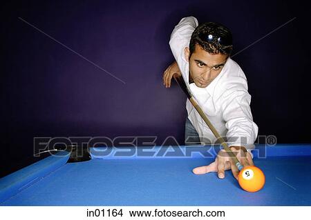 Young man preparing to hit pool ball View Large Photo Image Picture - Young man preparing to hit pool ball. Fotosearch
