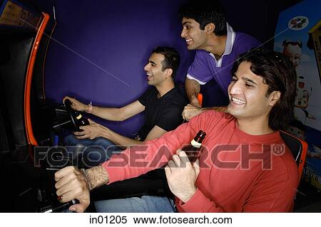 Young men in amusement arcade View Large Photo Image Stock Photography - Young men in amusement arcade. Fotosearch