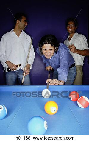 Young men playing pool View Large Photo Image Stock Photo - Young men playing pool. Fotosearch
