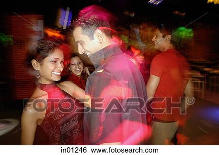 Young people dancing in night club, couple in the foreground View Large Photo Image Stock Photograph - Young people dancing in night club, couple in the foreground. Fotosearch