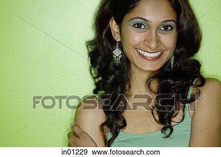 Young woman in green tank top, looking at camera, smiling View Large Photo Image Stock Photo - Young woman in green tank top, looking at camera, smiling. Fotosearch