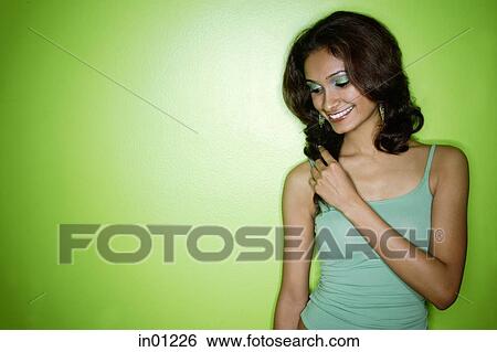 Young woman in green tank top, looking down View Large Photo Image Stock Photograph - Young woman in green tank top, looking down. Fotosearch