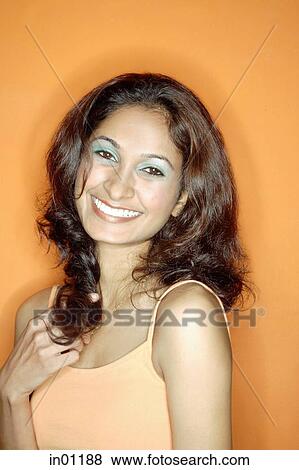 Young woman in orange tank top, against orange background View Large Photo Image Stock Photo - Young woman in orange tank top, against orange background. Fotosearch