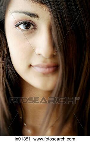 Stock Image - Young woman looking at camera, portrait. Fotosearch