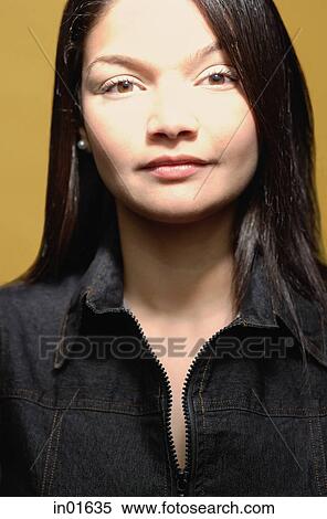 Stock Photography - Young woman looking at camera, portrait. Fotosearch