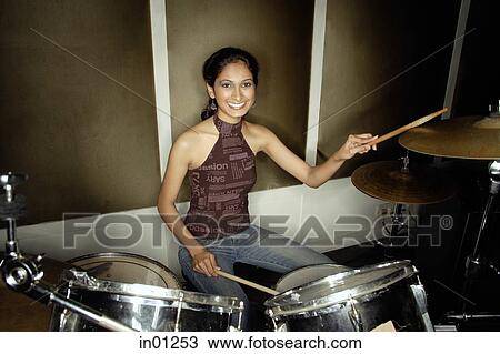 Young woman playing drums View Large Photo Image Stock Image - Young woman playing drums. Fotosearch